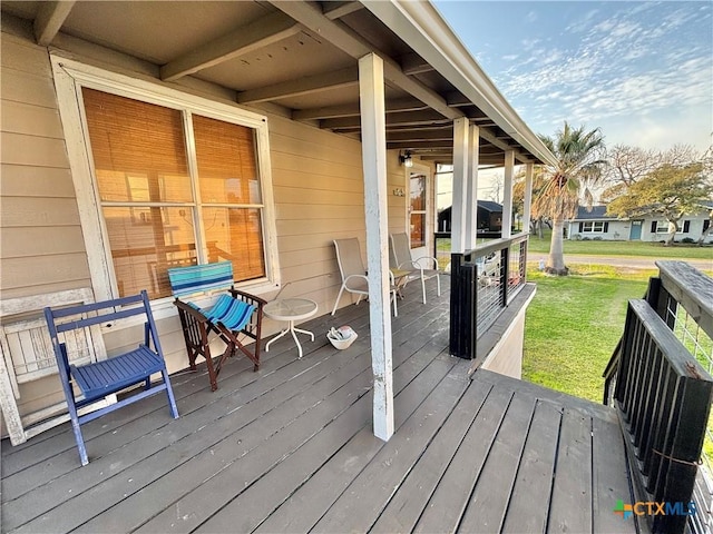 wooden terrace with grilling area and a lawn