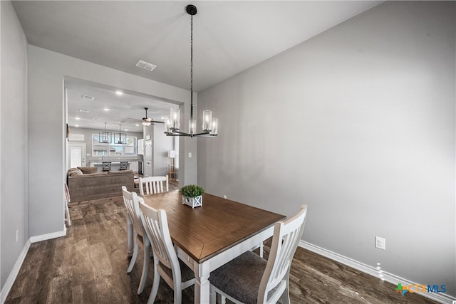 dining room with ceiling fan with notable chandelier and hardwood / wood-style flooring