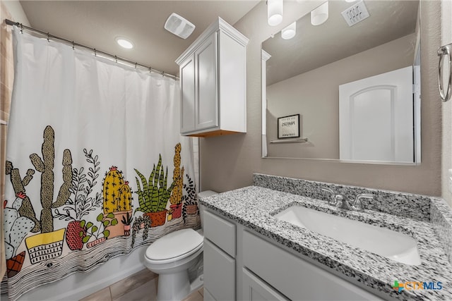 full bathroom with tile patterned floors, vanity, toilet, and shower / tub combo