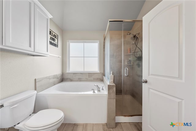 bathroom with wood-type flooring, separate shower and tub, toilet, and vaulted ceiling