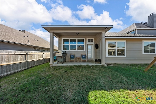 back of property featuring a patio and a lawn