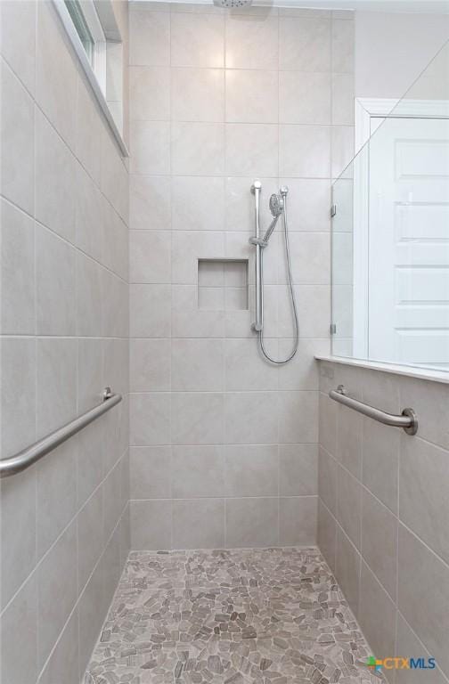 bathroom with tiled shower