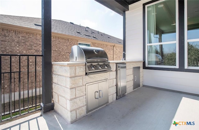 view of patio featuring area for grilling and a grill