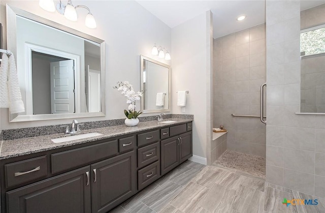 bathroom featuring vanity and tiled shower