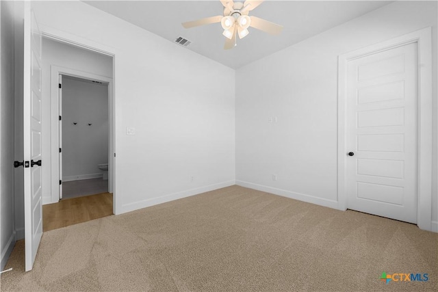 unfurnished bedroom featuring carpet floors, baseboards, visible vents, and a ceiling fan