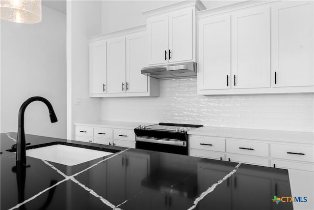 kitchen featuring under cabinet range hood, electric range, white cabinetry, and tasteful backsplash