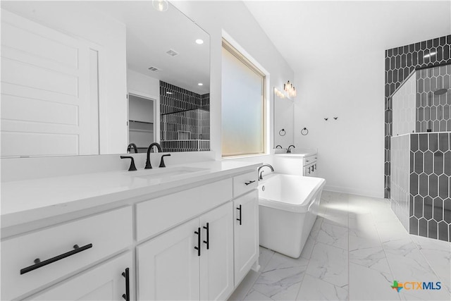 bathroom with recessed lighting, vanity, a freestanding bath, marble finish floor, and tiled shower