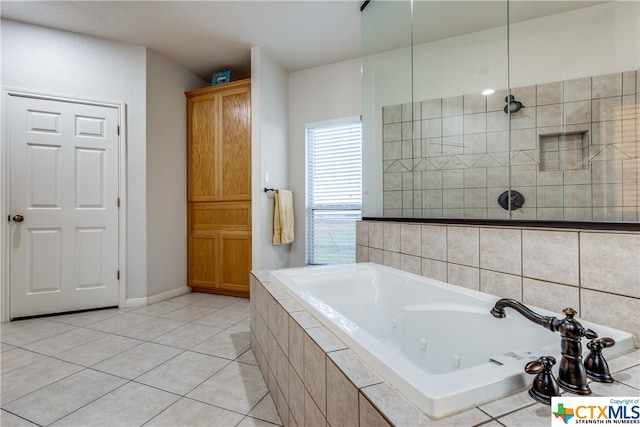 bathroom with tiled bath and tile patterned floors