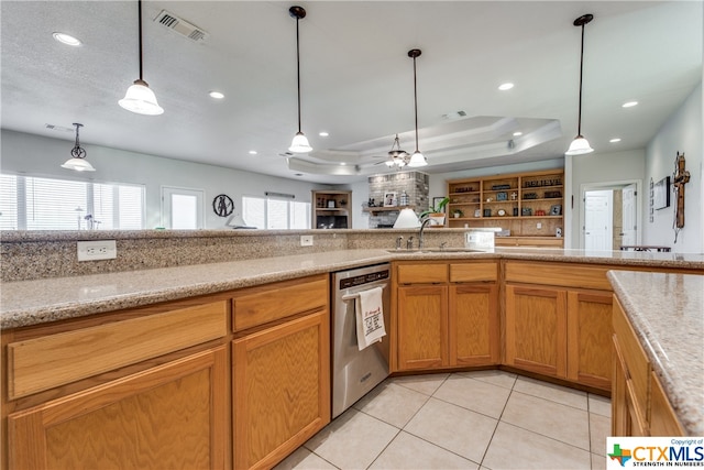 kitchen featuring a wealth of natural light, a raised ceiling, sink, and dishwasher