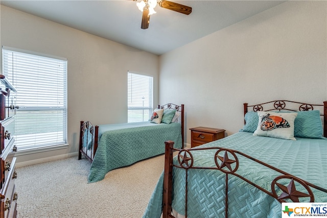 carpeted bedroom featuring multiple windows and ceiling fan