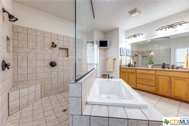 bathroom with vanity, a textured ceiling, tile patterned floors, and independent shower and bath