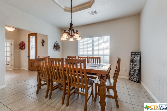 tiled dining room featuring a chandelier and a textured ceiling