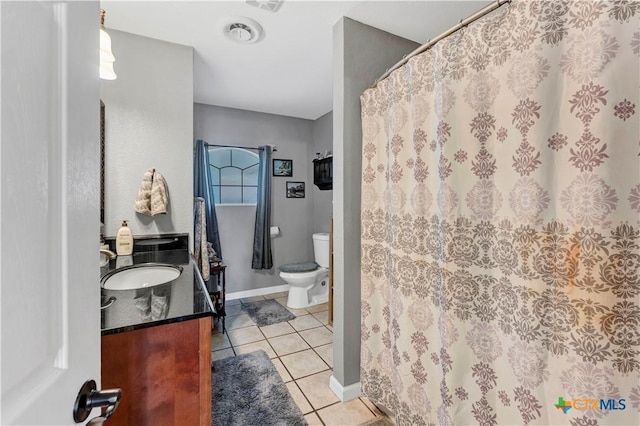 bathroom with tile patterned floors, vanity, and toilet