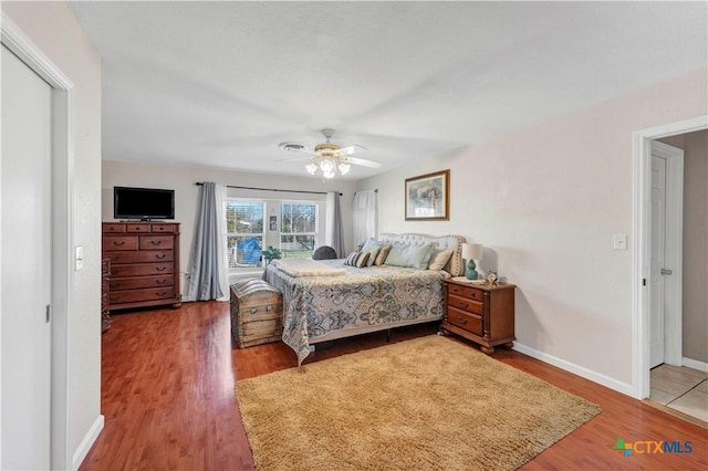 bedroom with hardwood / wood-style flooring and ceiling fan