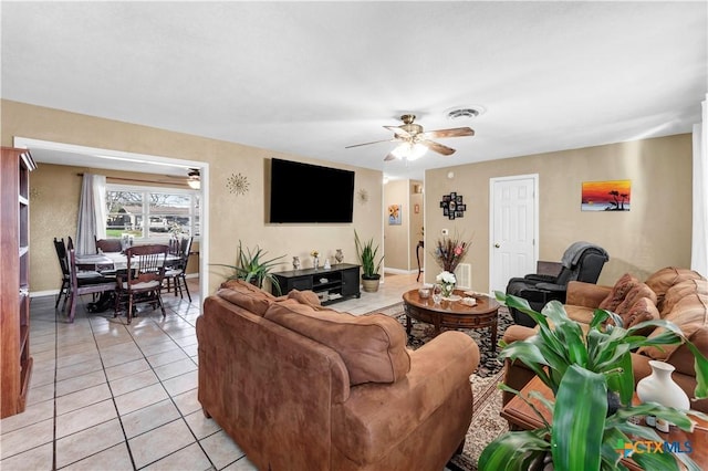 tiled living room with ceiling fan