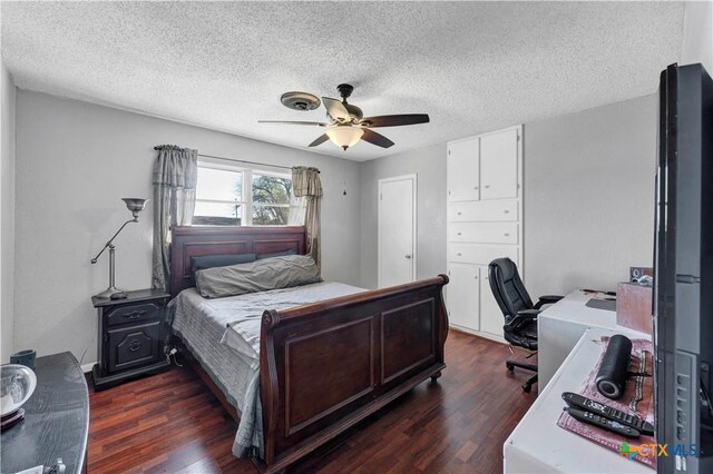bedroom featuring a textured ceiling, dark wood-style flooring, and ceiling fan