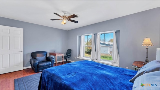 bedroom featuring ceiling fan and dark wood-type flooring