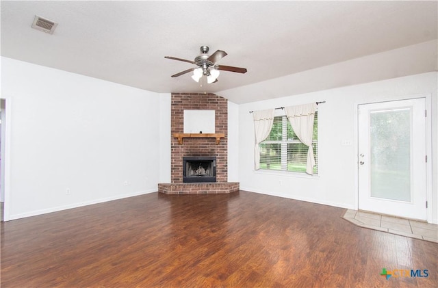 568 Morgans Point Rd, Belton, TX 76513 - unfurnished living room featuring ceiling fan, wood finished floors, lofted ceiling, and a brick fireplace