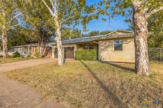 single story home featuring a front yard and a garage