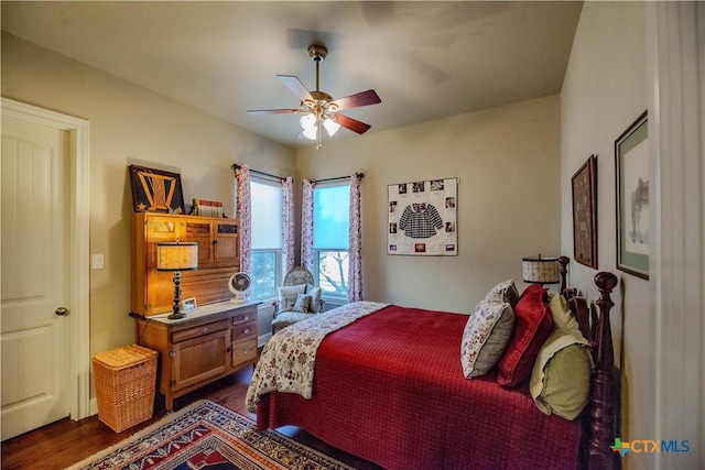 bedroom featuring dark wood-style flooring and ceiling fan