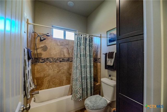 bathroom with shower / tub combo and toilet