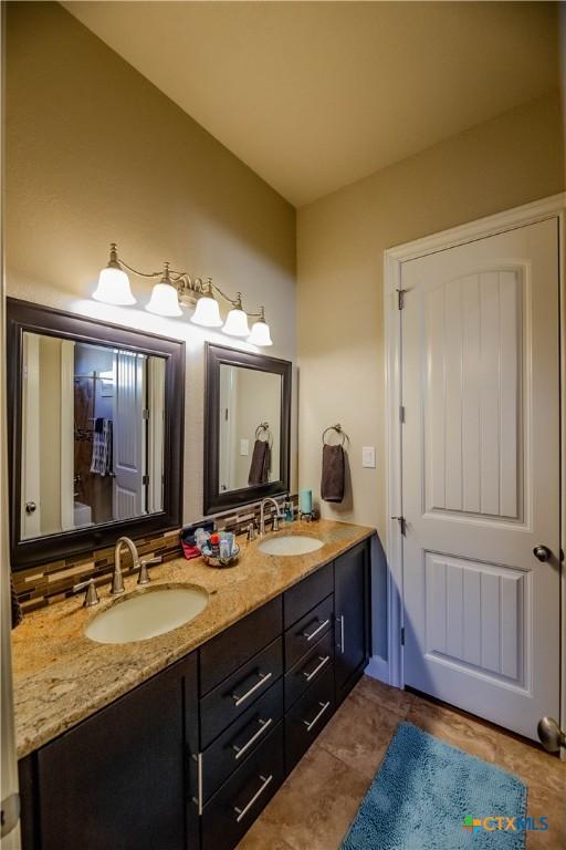 bathroom with double vanity and a sink