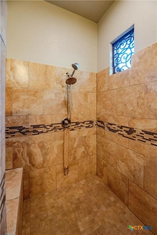 bathroom with tiled shower