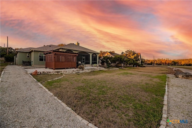 view of front of house featuring a front lawn and a sunroom