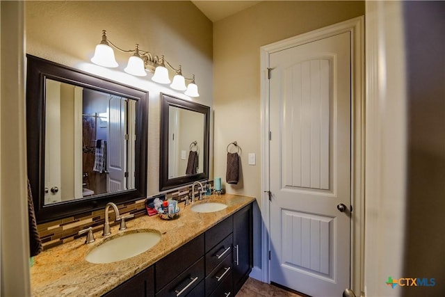 full bathroom featuring tasteful backsplash, a sink, and double vanity