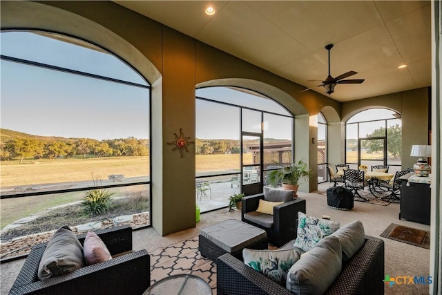 sunroom with a ceiling fan