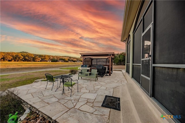 patio terrace at dusk with a pergola