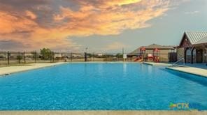 9505 Shimla Dr, Killeen, TX 76542 - pool at dusk featuring a community pool