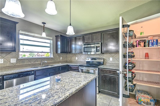 9505 Shimla Dr, Killeen, TX 76542 - kitchen featuring stainless steel appliances, a sink, light stone counters, and decorative backsplash