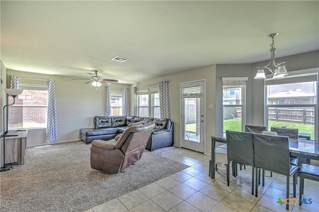 9505 Shimla Dr, Killeen, TX 76542 - living area with light tile patterned floors, a ceiling fan, a textured ceiling, baseboards, and a chandelier