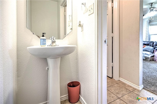 9505 Shimla Dr, Killeen, TX 76542 - bathroom with tile patterned flooring, a ceiling fan, a textured wall, and a sink
