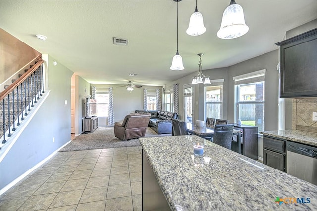 9505 Shimla Dr, Killeen, TX 76542 - kitchen with baseboards, light stone counters, ceiling fan, dishwasher, and hanging light fixtures