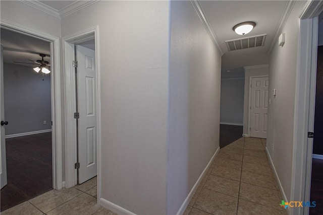 corridor featuring crown molding and light tile patterned flooring