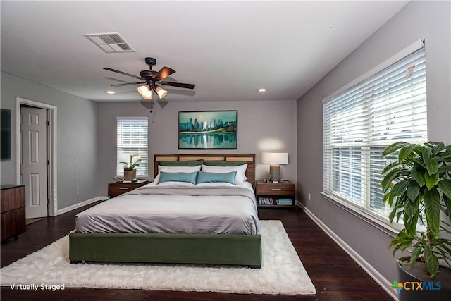 bedroom with ceiling fan and dark hardwood / wood-style flooring