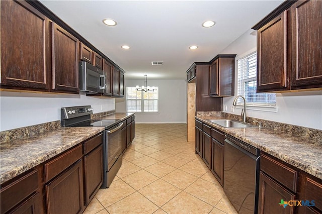 kitchen featuring a healthy amount of sunlight, sink, stainless steel appliances, and an inviting chandelier