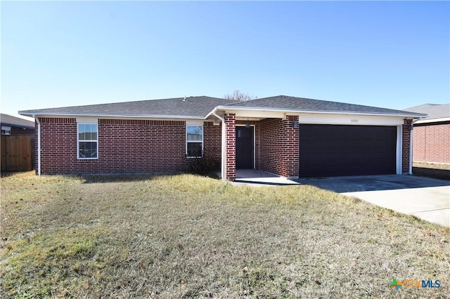 ranch-style house featuring a garage and a front yard