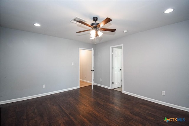 spare room with ceiling fan and dark wood-type flooring