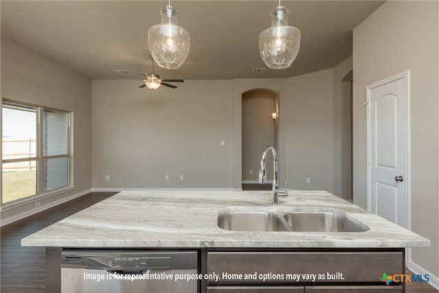 kitchen with stainless steel dishwasher, sink, dark wood-type flooring, and decorative light fixtures