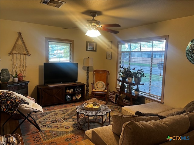 living room featuring a wealth of natural light and ceiling fan