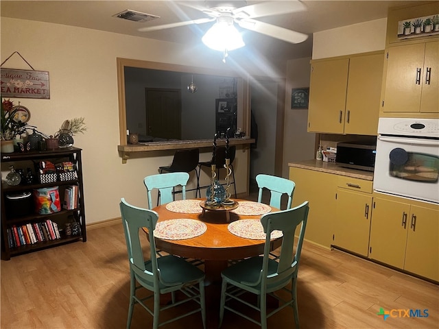 dining area featuring light hardwood / wood-style floors and ceiling fan