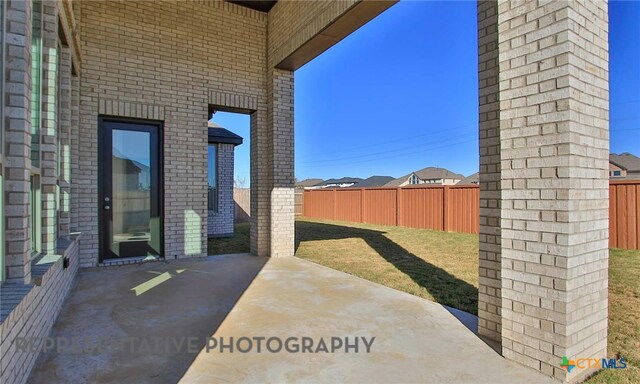 view of patio featuring fence