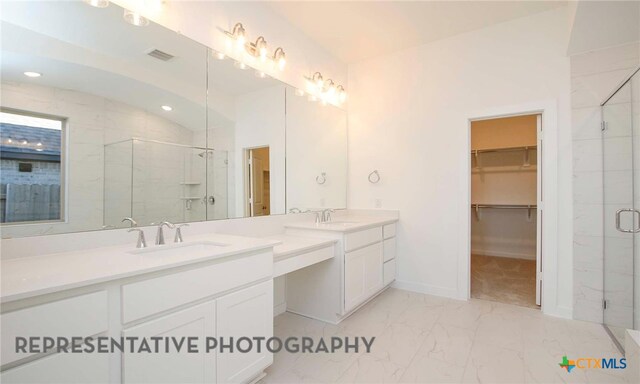 bathroom with visible vents, a stall shower, a sink, a spacious closet, and marble finish floor