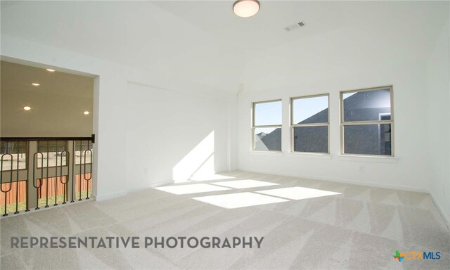 carpeted empty room with recessed lighting, visible vents, and baseboards