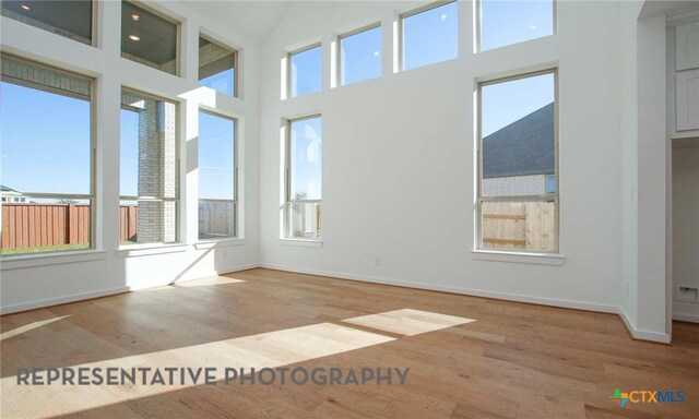 unfurnished sunroom featuring lofted ceiling and a wealth of natural light