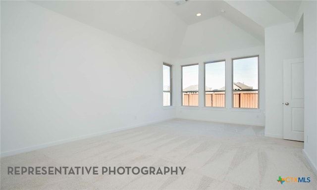 carpeted spare room featuring recessed lighting, high vaulted ceiling, and baseboards