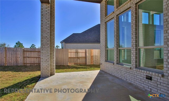 view of patio featuring fence